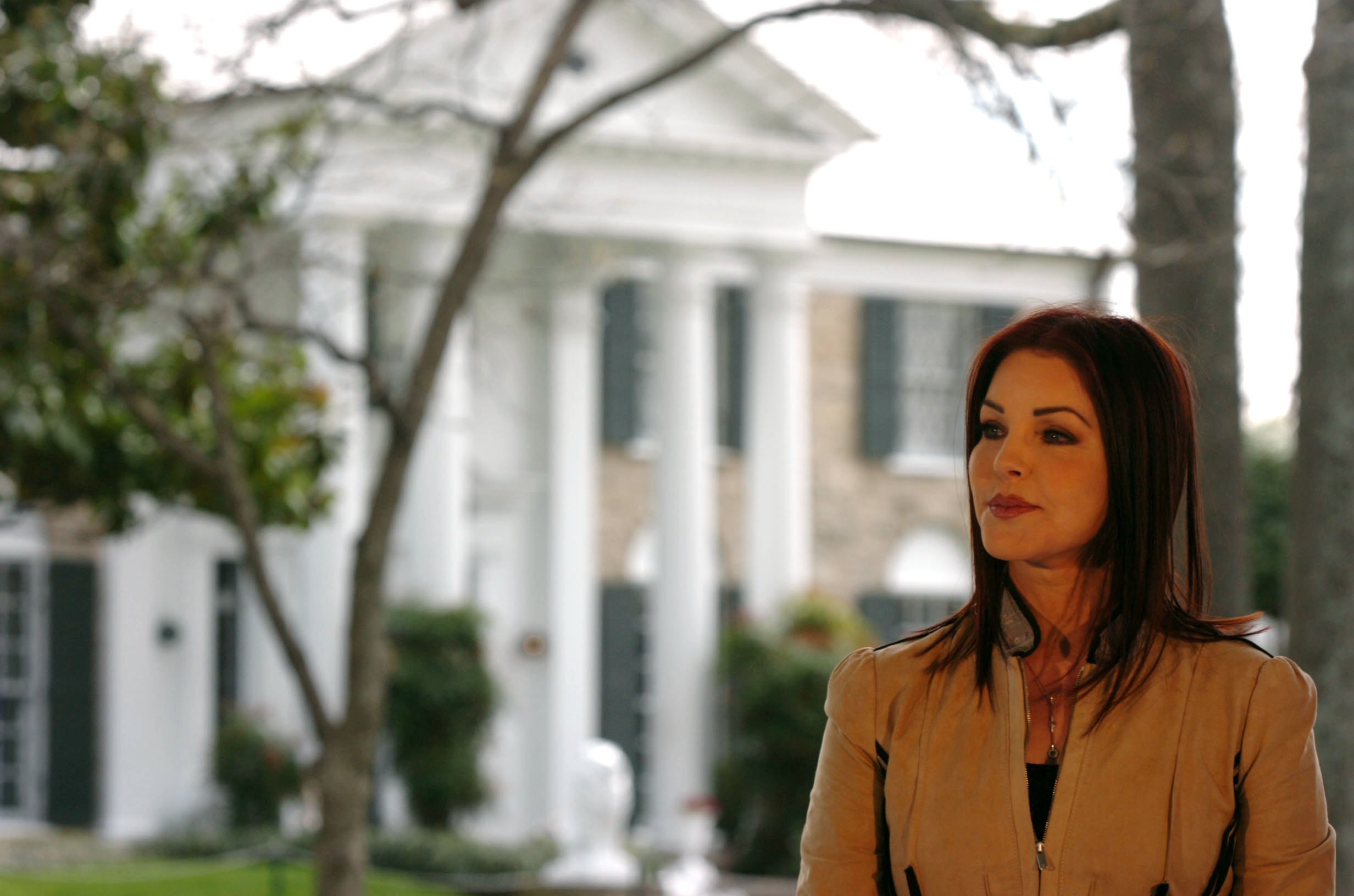 MEMPHIS, TN - MARCH 27:  Priscilla Presley listens to Secretary of the Interior Gale Norton address a group of Elvis fans on the front lawn of Graceland March 27, 2006 in Memphis, Tennessee. Graceland, the former home of the king of rock