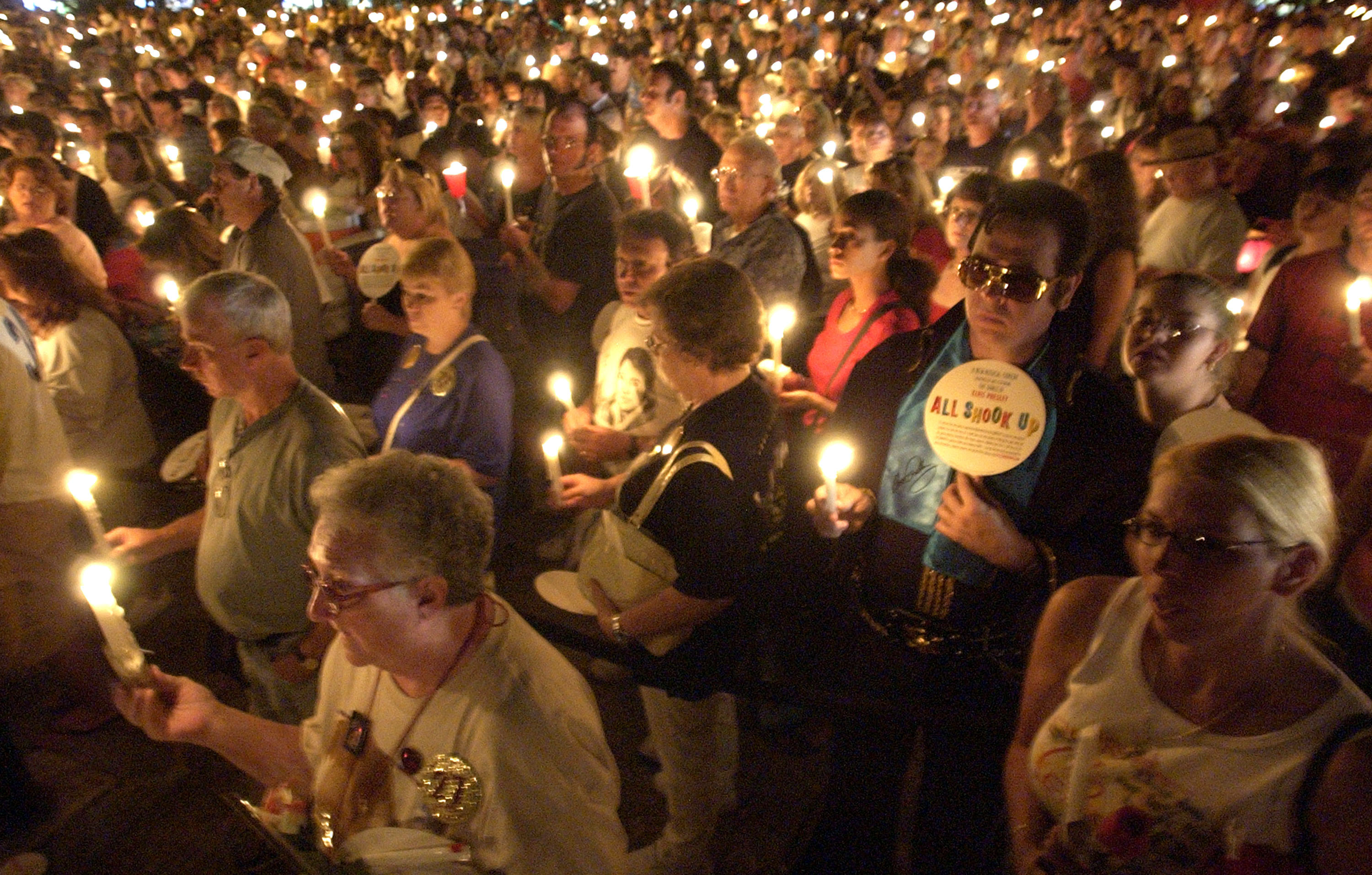 MEMPHIS, TN - AUGUST 15:  Thousands of Elvis fans hold their candles during the annual candle light vigil August 15, 2004 at Graceland in Memphis, Tennessee. The vigil is the grand finale of the annual 