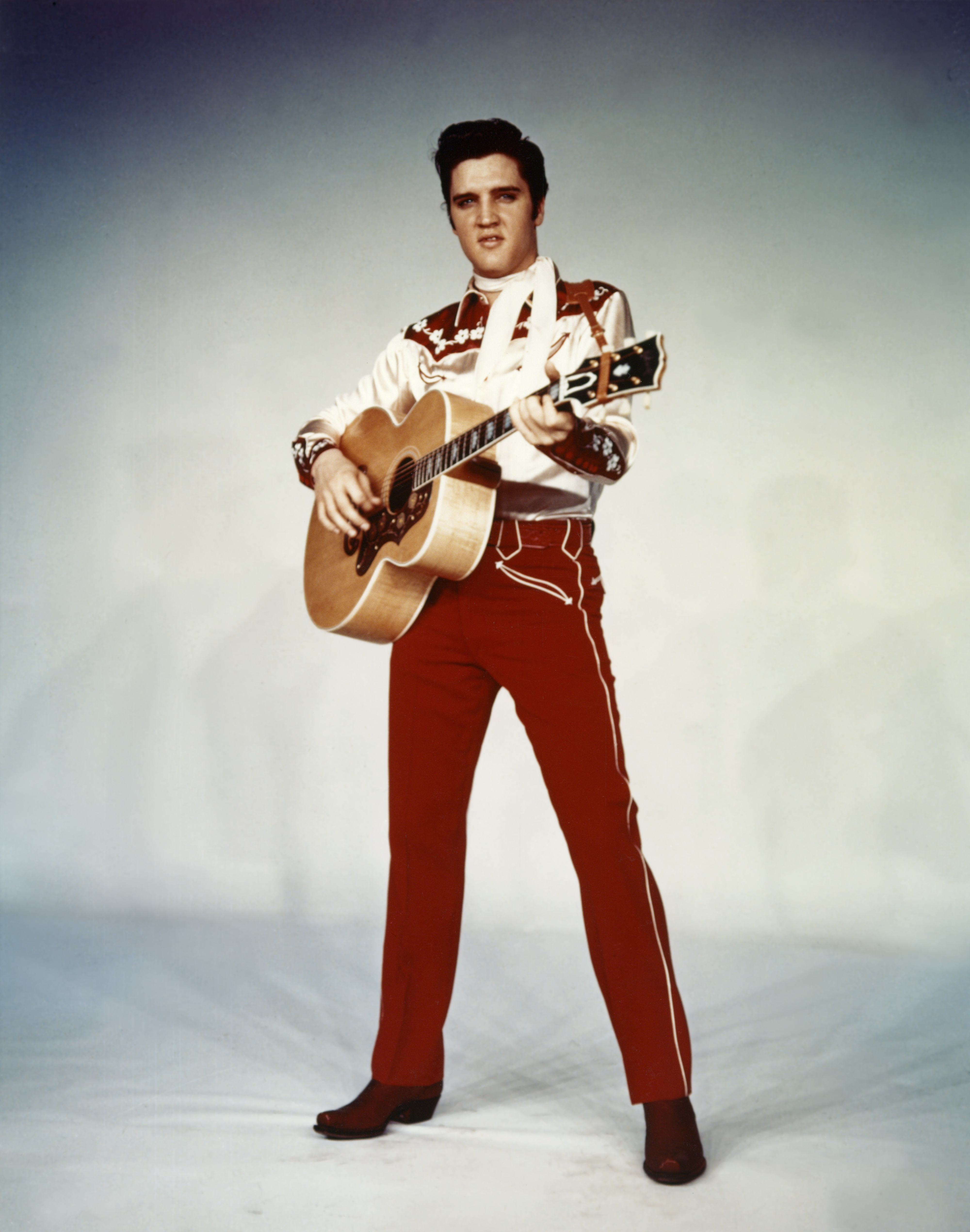 American singer and actor Elvis Presley promoting the movie Loving You, written and directed by Hal Kanter. (Photo by Paramount Pictures/Sunset Boulevard/Corbis via Getty Images)