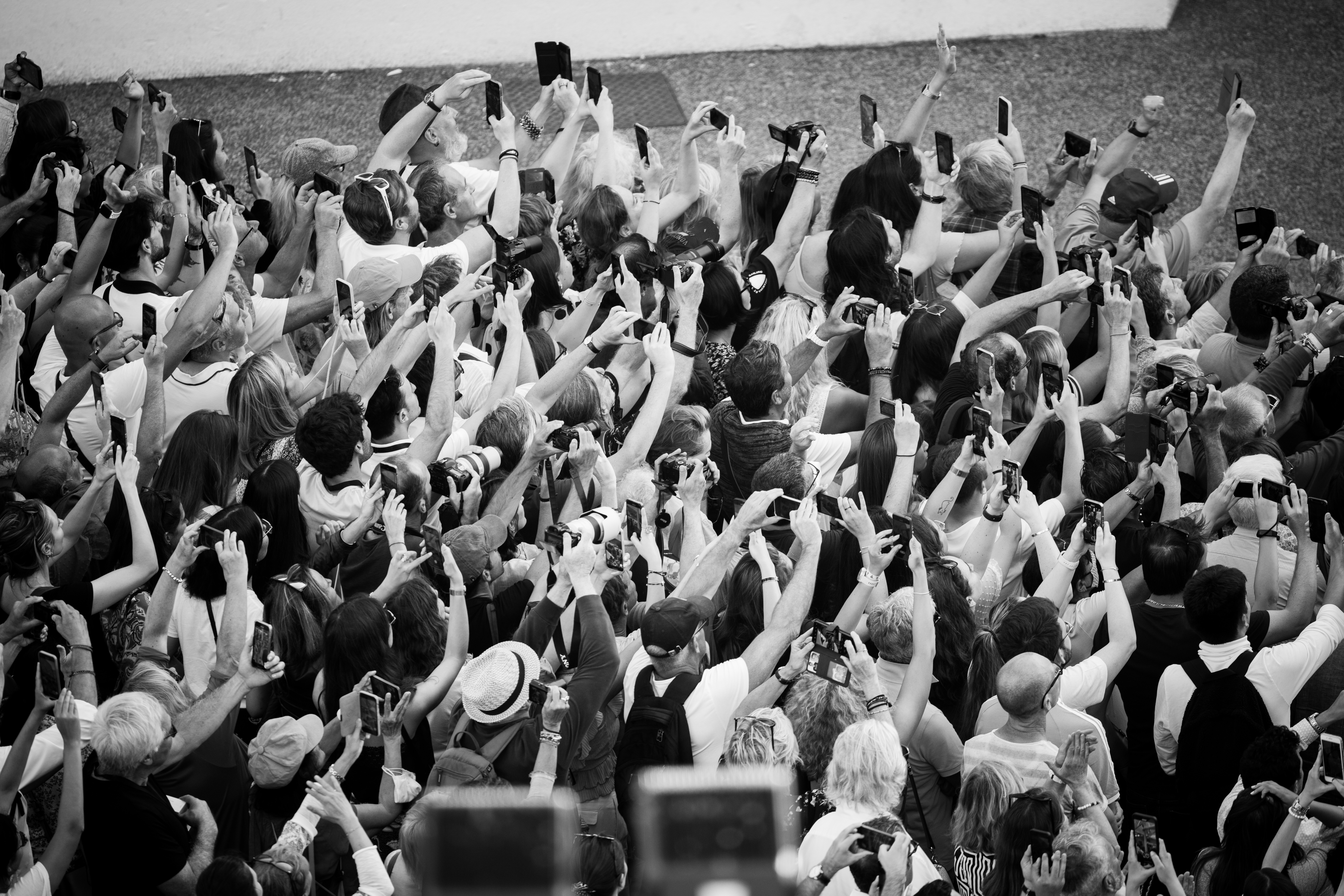 CANNES, FRANCE - MAY 25: (EDITORS NOTE : Image has been converted to black and white) Fans gather outside the red carpet before the screening of 