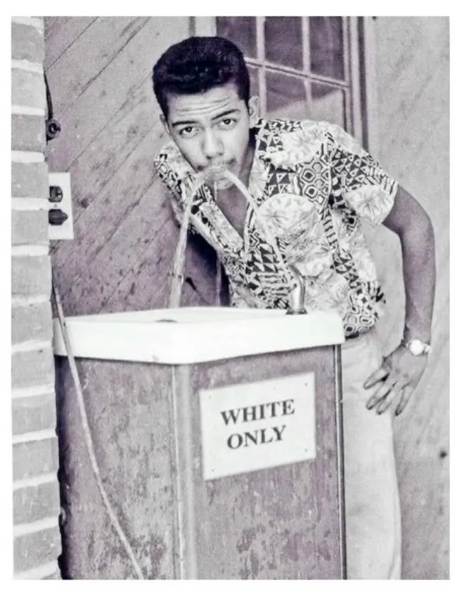 A civil rights activist drinks from a whites only fountain in Oklahoma, 1964