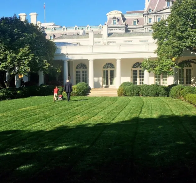 President Trump walking with a boy who asked if he could mow the White House lawn