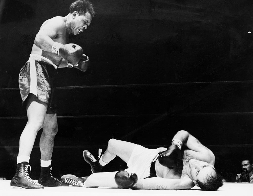 Archie Moore Stands Over Opponent In Ring Archie Moore Stands Over Opponent In Ring