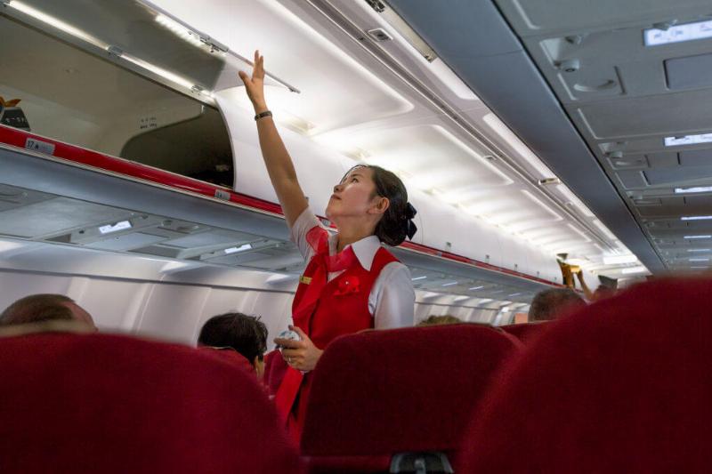 Flight attendant inside an air Koryo tupolev plane, Pyongan Province, Pyongyang, North Korea Flight attendant inside an air Koryo tupolev plane, Pyongan Province, Pyongyang, North Korea