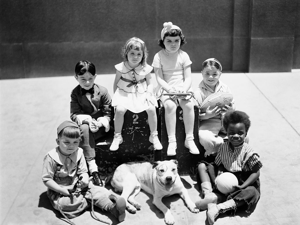 the little rascals sitting on a trunk the little rascals with spanky holding a football