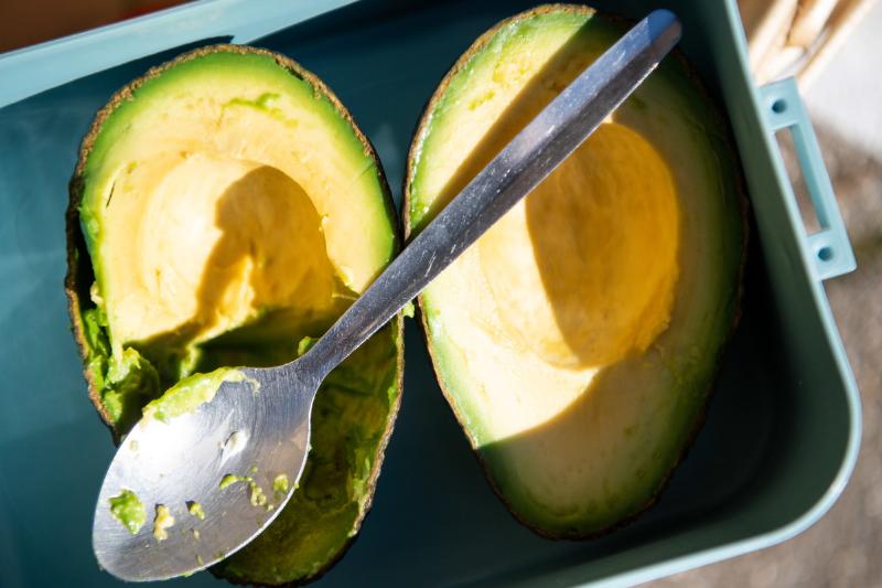 Avocado increases HDL cholesterol, good for the heart A spoon lies over a sliced avocado.