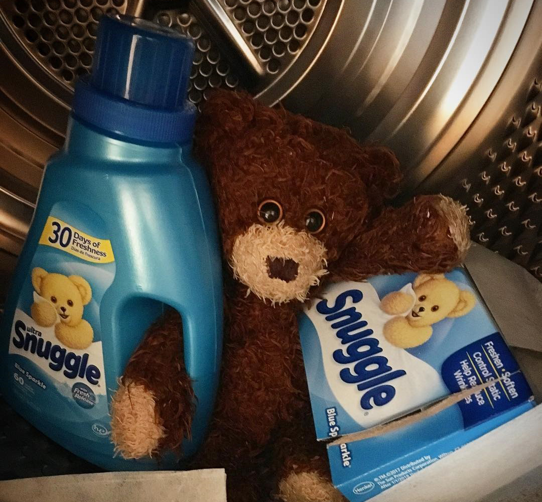fabric softener fabric softener getting held by a cute stuffed animal inside of a dryer