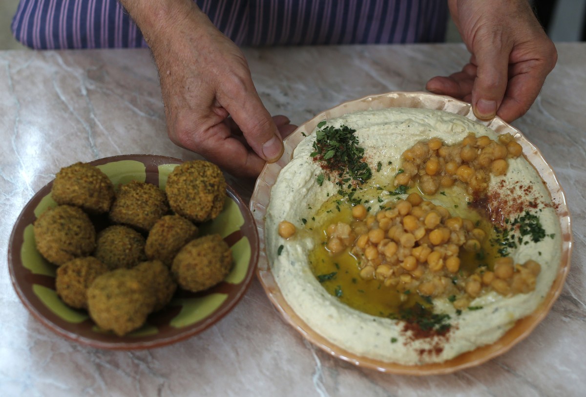 Both chickpeas and hummus are heart-healthy Palestinian restaurant owner Yasser Taha displays a plate of hummus, a paste made from chickpeas, and a bowel of falafel which are made from mashed and fried chickpeas