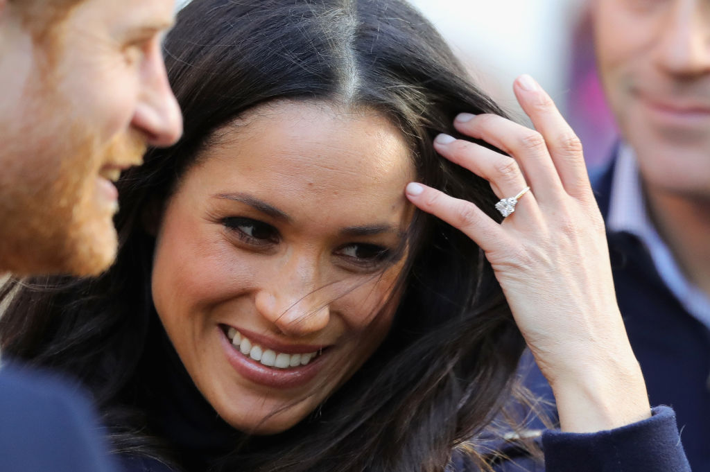 Prince Harry and Meghan Markle Prince Harry and Meghan Markle while Markle shows her diamond ring