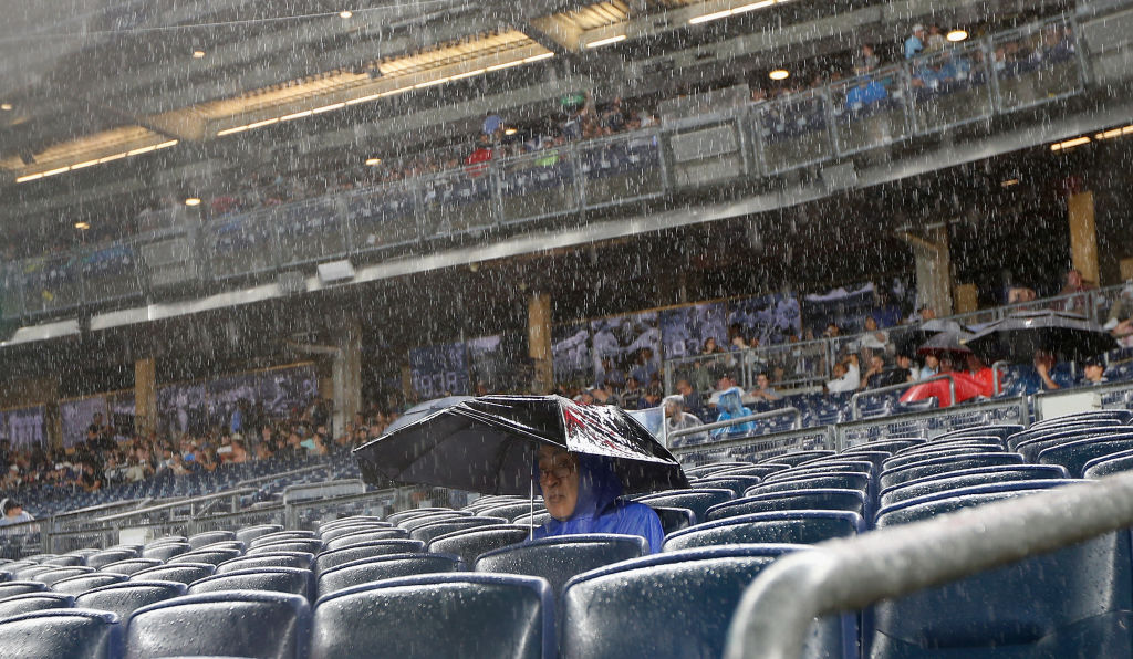 Rain Or Shine Man sitting alone in the rain