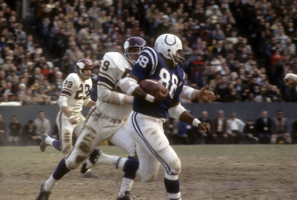 John Mackey-106921900 BALTIMORE, MD - CIRCA 1965:  John Mackey #88 of the Baltimore Colts runs away from Lonnie Warwick #59 of the Minnesota Vikings during an NFL football game at Memorial Stadium circa 1965 in Baltimore, Maryland. Mackey played for the Colts from 1963-71.