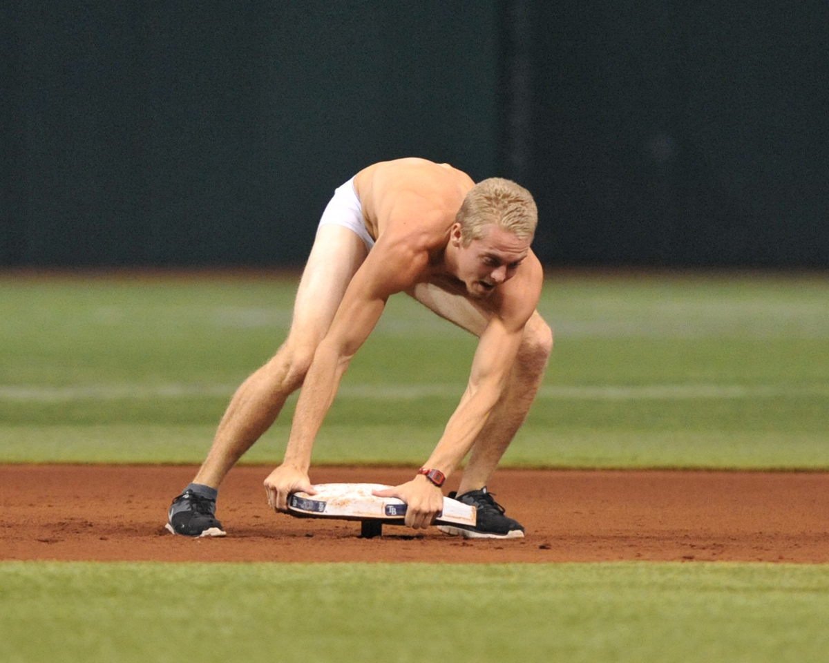 streaker tampa bay rays-180831468 A fan of the Tampa Bay Rays runs to the field and attempts to steal second base during play against the Texas Rangers September 16, 2013 at Tropicana Field in St. Petersburg, Florida.
