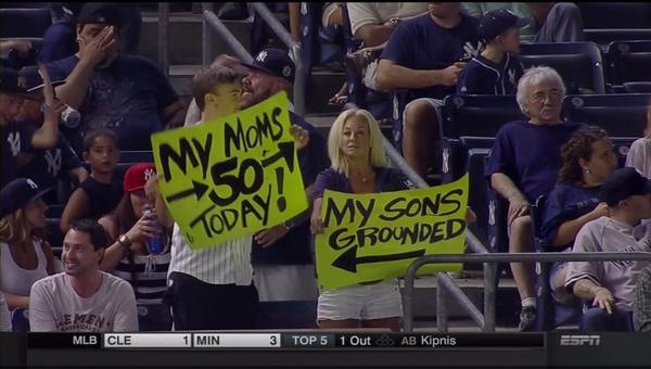 baseball signs fans with signs at a baseball game