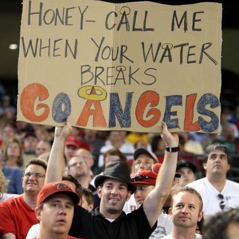 angels fan priorities an angels fan with a sign for his wife