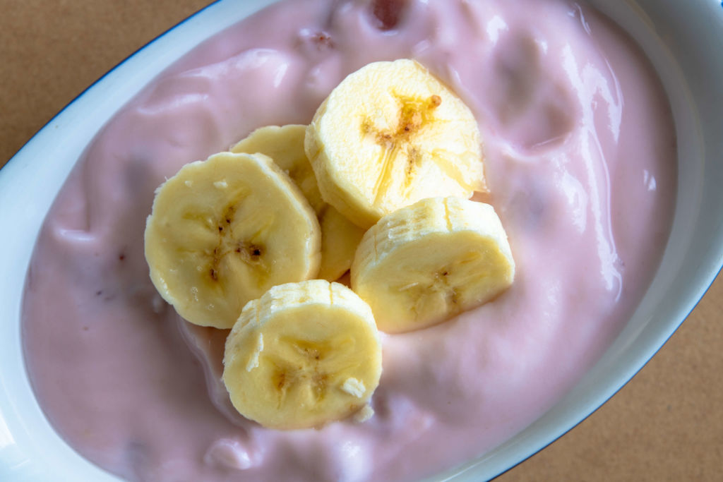 bananas 1067094934 banana slices on top of strawberry yogurt