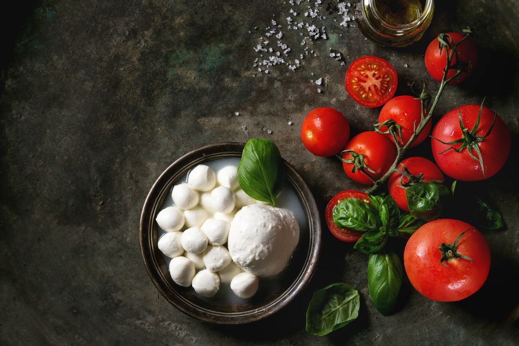 mozzarella 957722476 mozzarella balls on a plate with basil and tomatoes