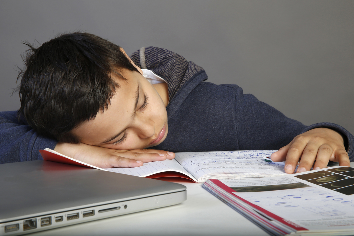 sleeping - 1132273146 12-year-old schoolboy falls asleep on his homework.