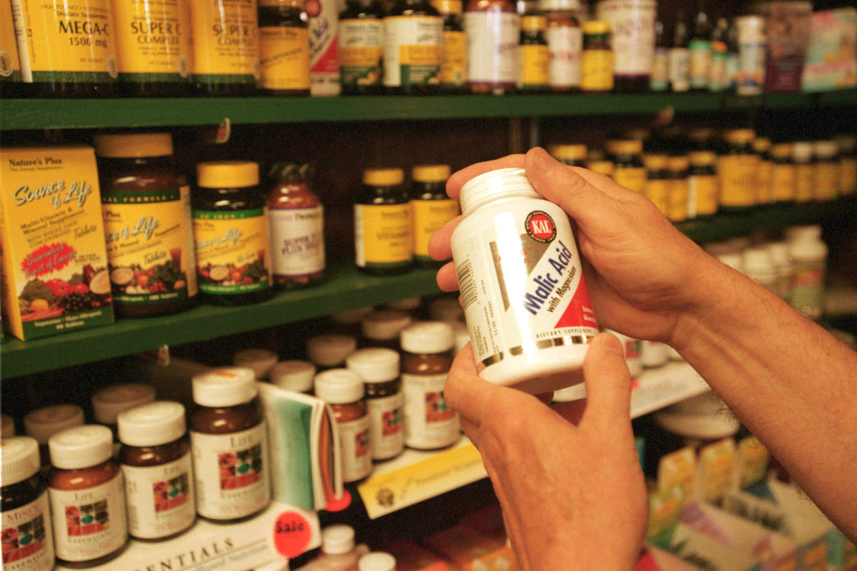 vitamins - 1324397 A customer looks at vitamins in a store.