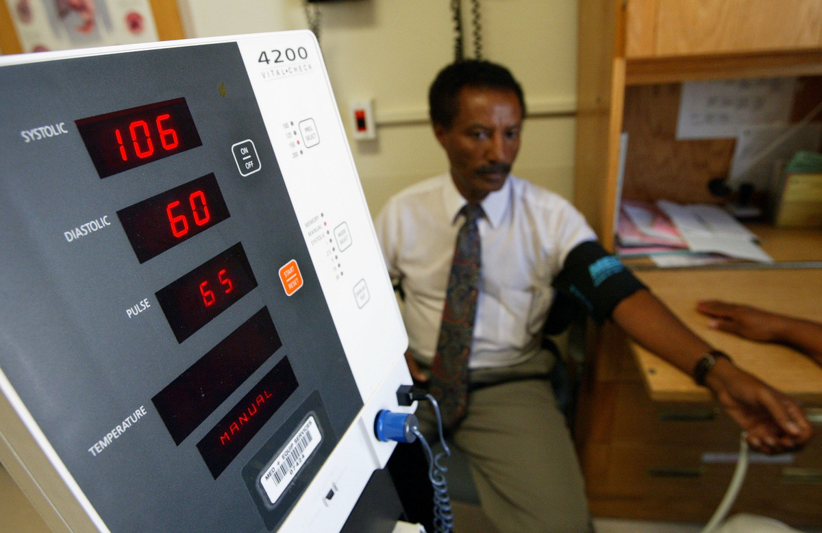 checking blood pressure - 2148933 Negash Berhe has his blood pressure checked with a monitor.