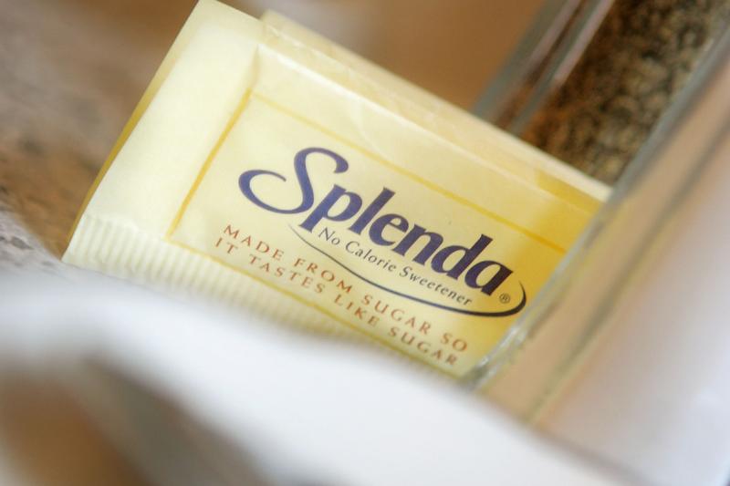 Splenda - 51829888 Packets of the popular sugar substitute Splenda are on a counter.