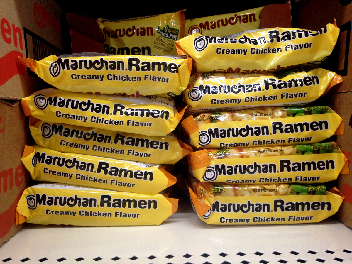 packaged ramen - 550448611 Dried ramen noodle packages are stacked on a store shelf.