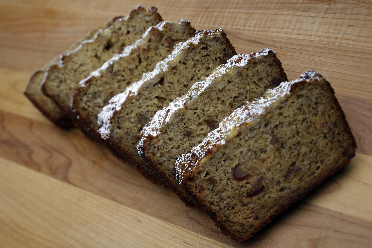 banana bread - 566029417 Banana bread from Huckleberry is laid out on a cutting board.