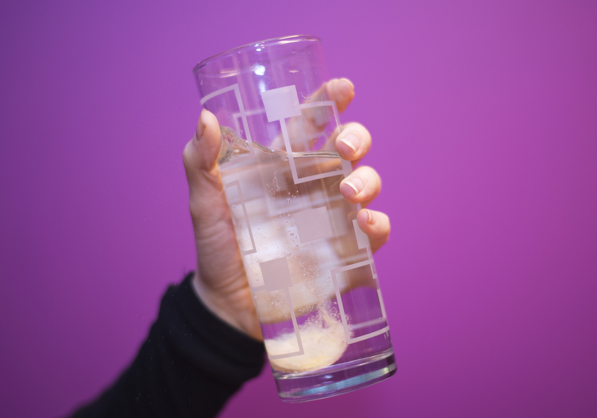 sparkling water - 624914420 A vitamin C tablet dissolves into sparkling water.