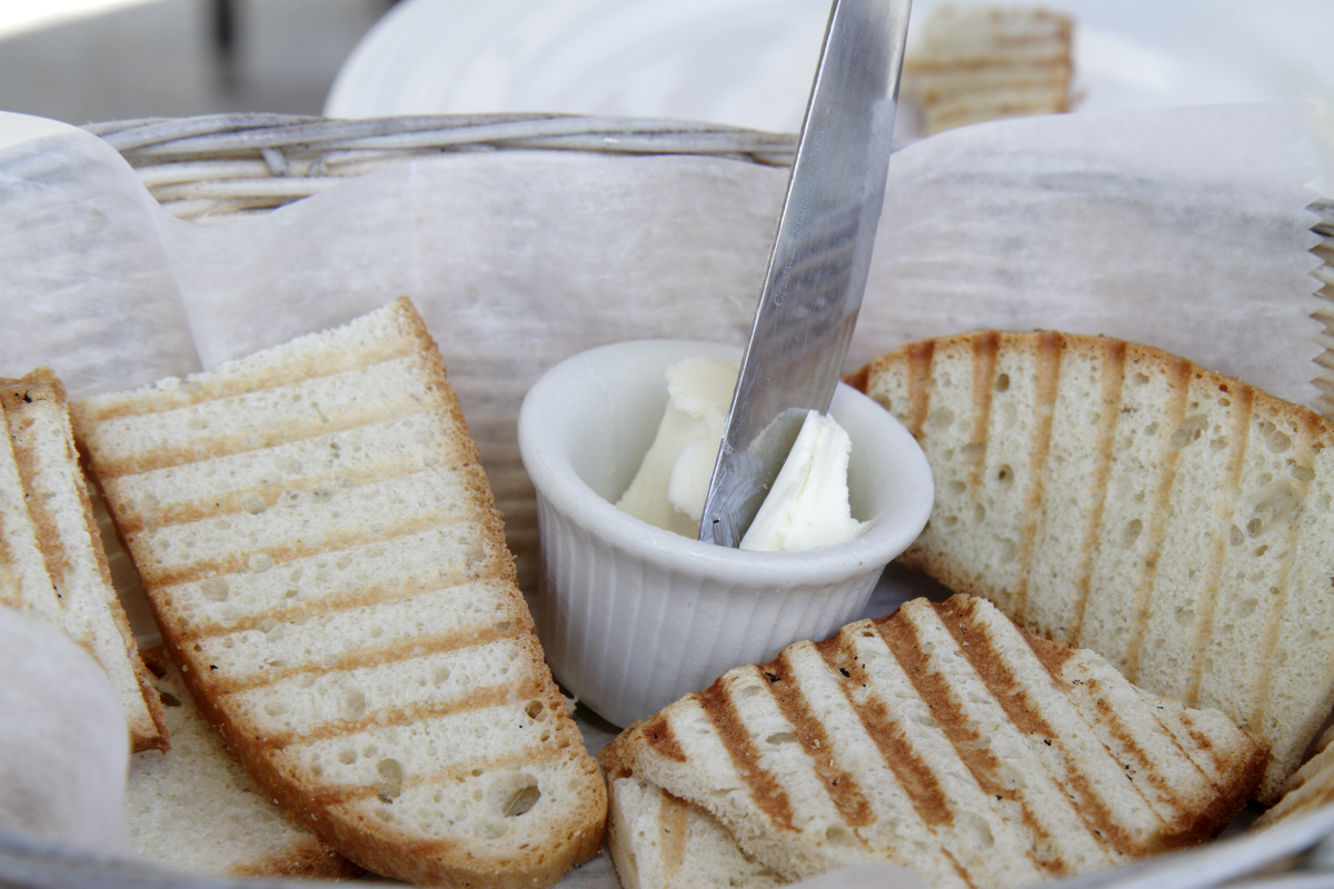 butter and toast - 630065030 Close-up shot displays butter with toast.