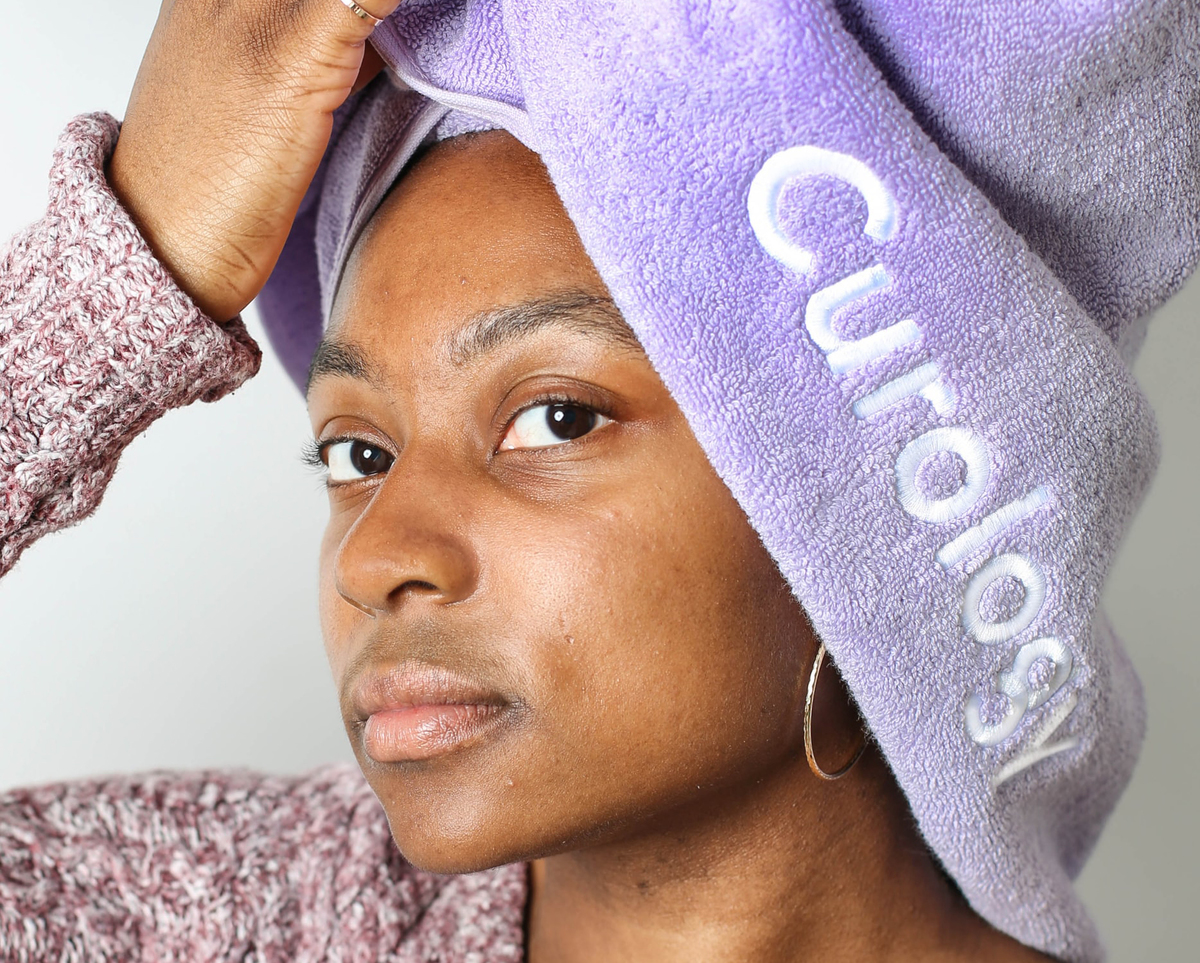 towel wrap Woman has her hair wrapped in a shower towel.