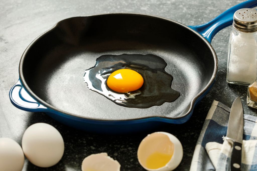eggs 1147809038 a raw egg in a frying pan