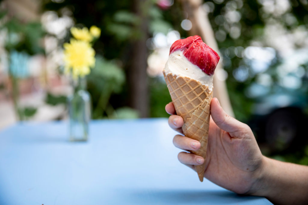 ice cream 1151583374 someone holding a vanilla ice cream cone