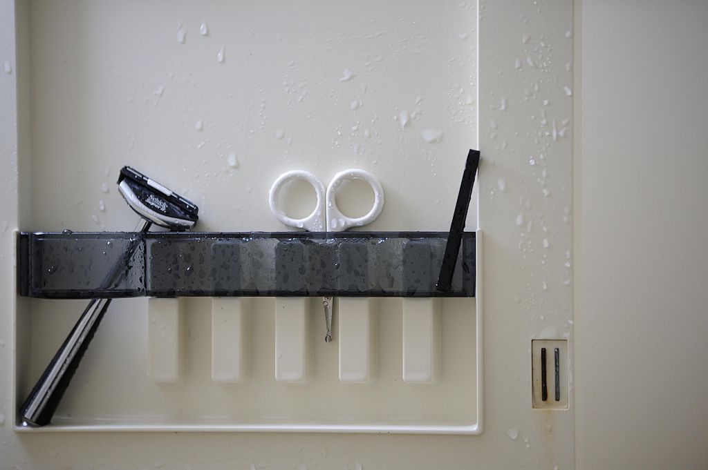 razor A straight razor and a small chisel are seen in the bathroom