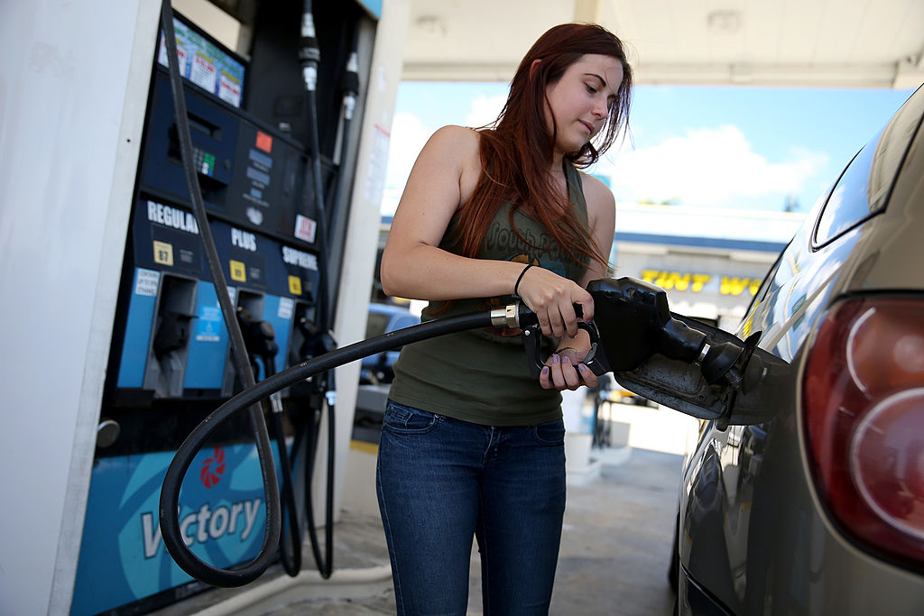 filling up Gabrielle Smith pumps gas