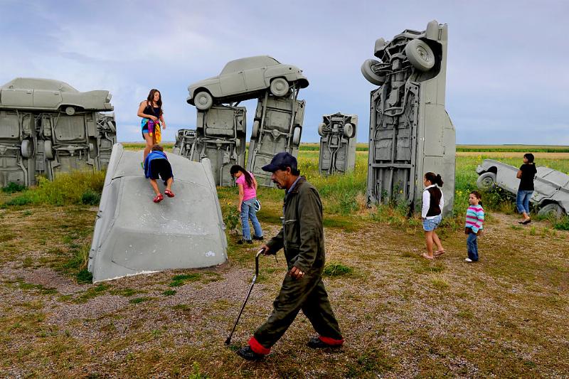carhenge 486270142 a family playing around the car sculptures at carhenge