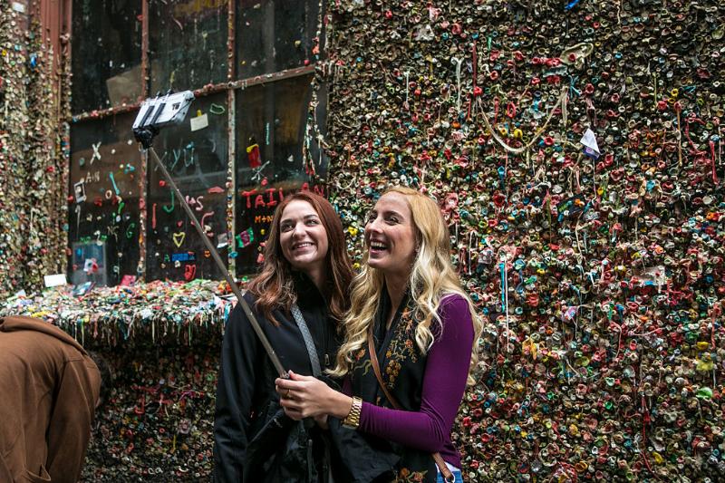 gum wall 496456560 two girls taking a selfie in front of a gum wall