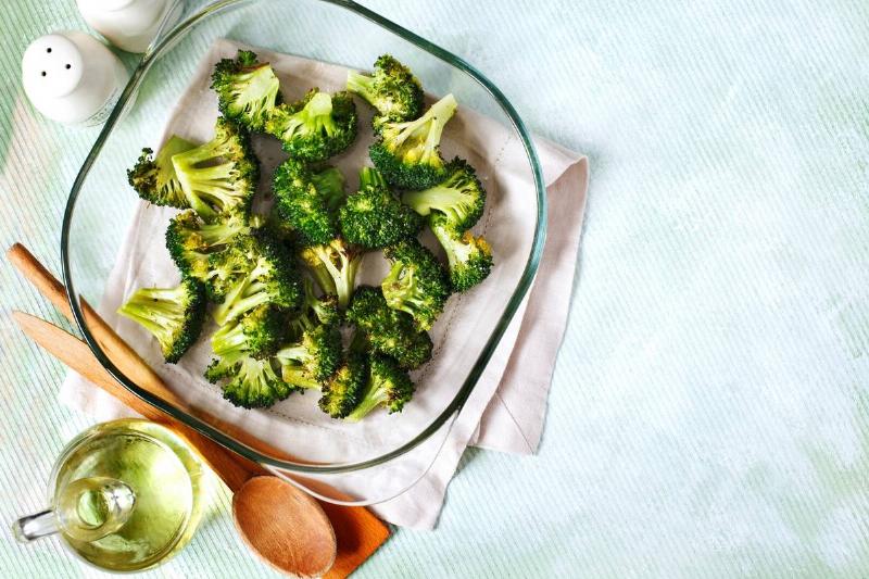 baked broccoli - 1162730688 A top view shows baked broccoli in a pan.