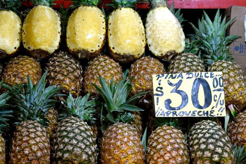 pineapple - 912368838 Whole pineapples are on sale at a Mexican market.