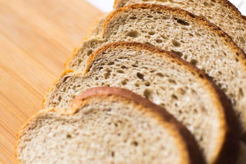 whole grain bread Slices of whole wheat bread are seen.