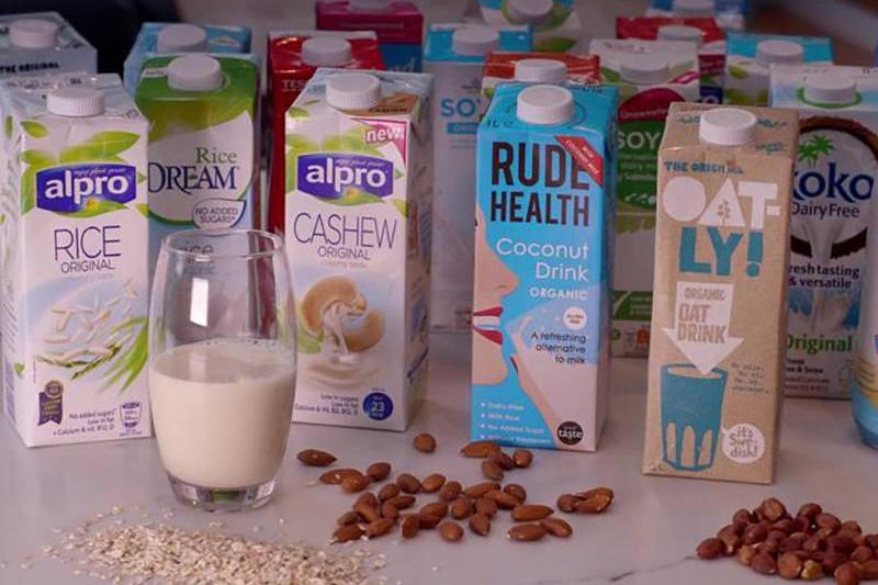 milk alternatives Several different cartons of milk alternatives are seen.