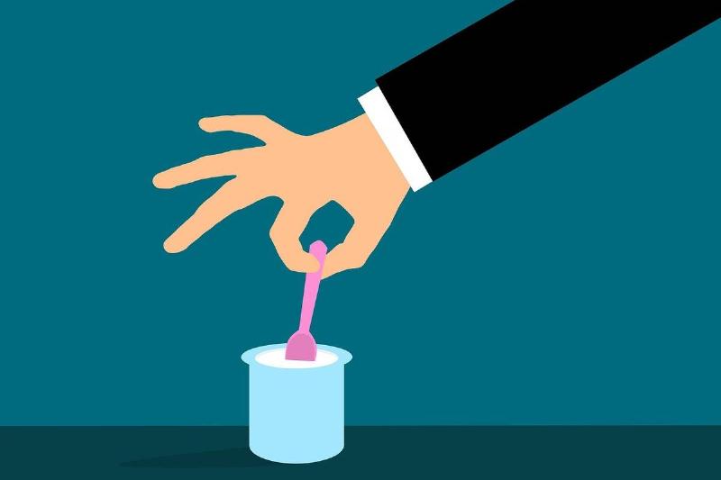 yogurt Clipart shows a man dipping a spoon into yogurt.