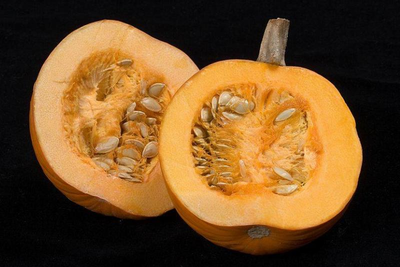 pumpkin seeds 481605299 Pumpkin cut in half showing seeds.