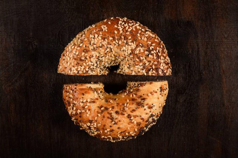 An everything bagel is cut in half.