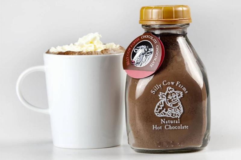 hot chocolate mix - 107977417 A cup of hot chocolate sits next to the chocolate mixture.