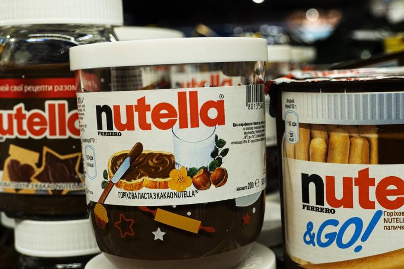 Nutella - 1191948992 Jars of nutella sit on a store shelf.
