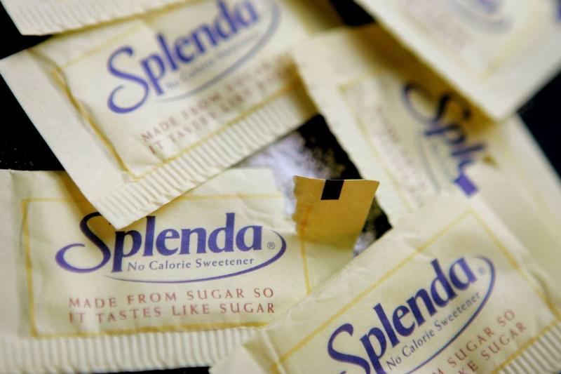 Splenda - 51829869 Packets of Splenda lie on a table.