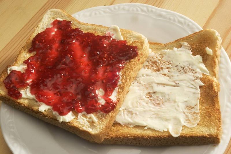 toast with jelly - 544245875 Two slices of toast are covered with jam and butter.