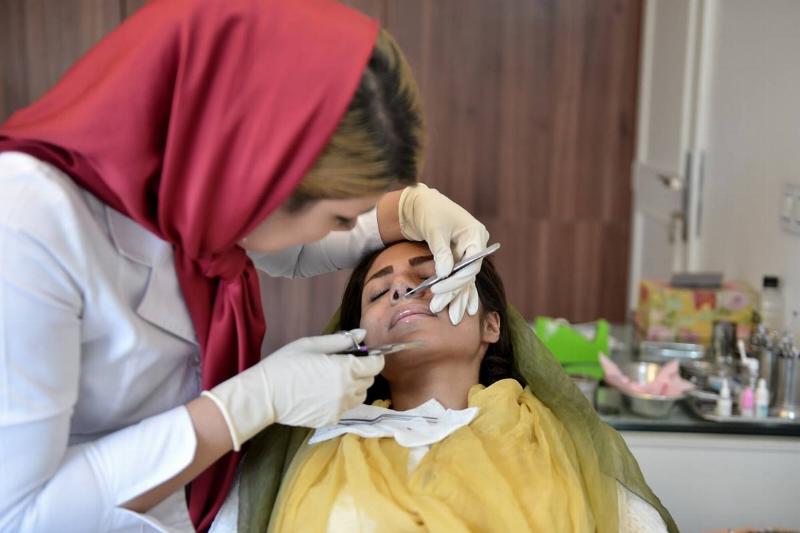 nose job - 859240622 A woman receives a nose job.