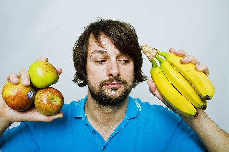 apples and bananas 129377773 Man deciding whether to eat apple or banana