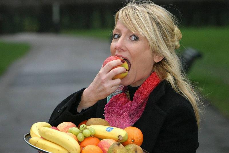 chewing 115366822 a woman taking a bite out of an apple