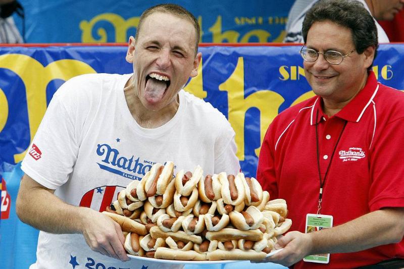 hot dogs 75030954 Joey Chestnut holding a plate of 66 hot dogs